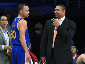 Golden State Warriors guard Stephen Curry, left, talks with coach Mark Jackson after achieving a triple-double, during the second half of an NBA basketball game against the Los Angeles Lakers, Friday, April 11, 2014, in Los Angeles. The Warriors won 112-95. (AP Photo/Mark J. Terrill)
